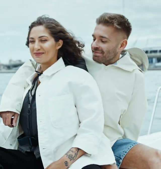 A couple laughing together on a sailboat